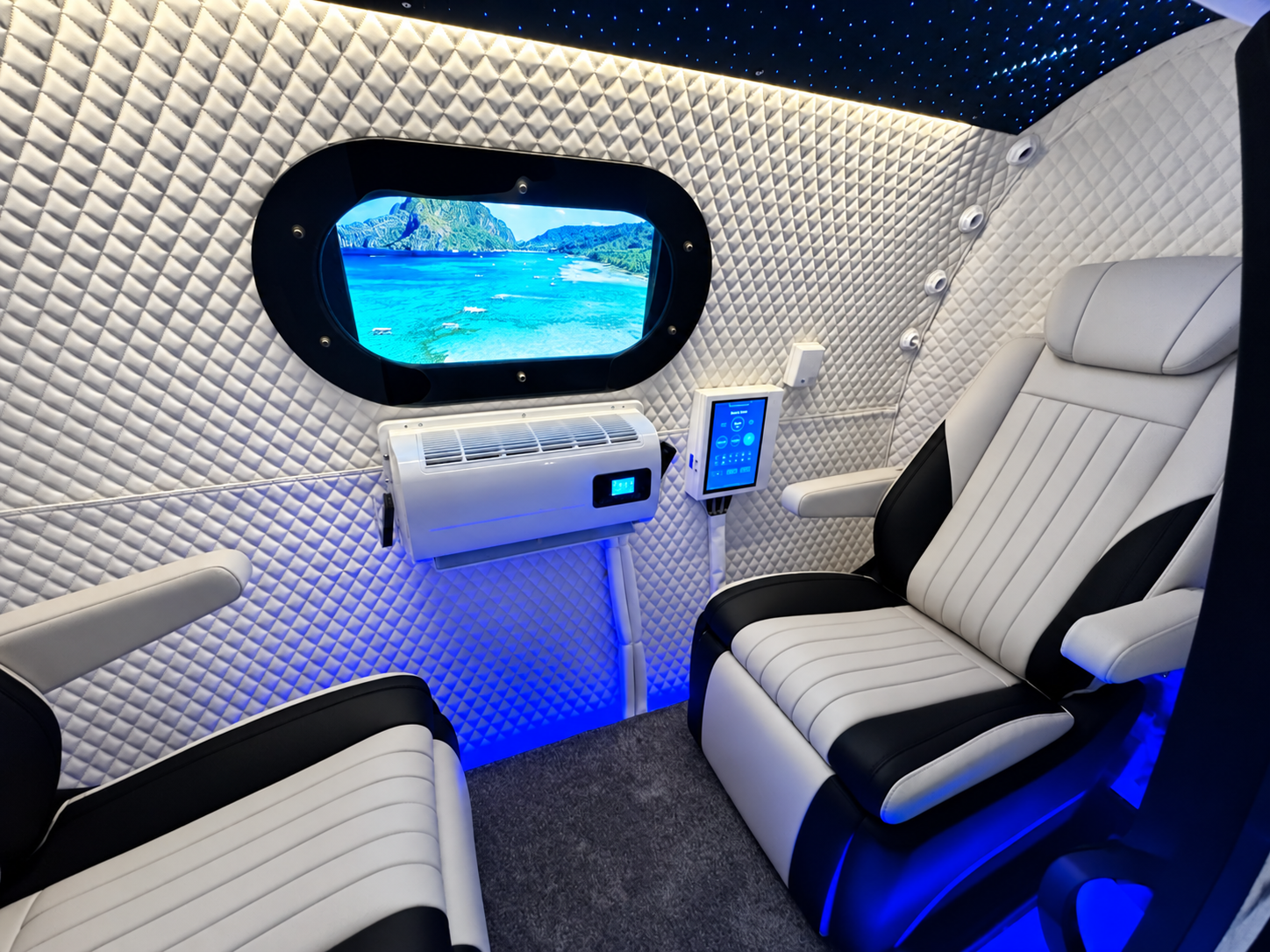 Two seats inside our mobile chamber, with the TV on and stars overhead